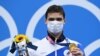 Yvgeny Rylov poses on the podium after the final of the men's 200-meter backstroke swimming event during the Tokyo 2020 Olympic Games in Tokyo on July 30, 2021.