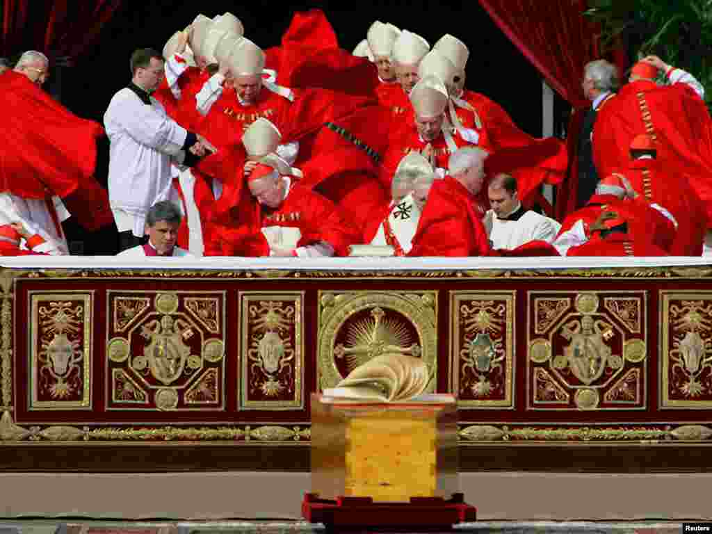 Cardinals' cassocks are blown by a gust of wind as they arrive for the funeral mass of the Pope John Paul II at St. Peter's Basilica in the Vatican, 8 April 2005. REUTERS 