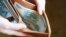 GENERIC – Russian rubles banknotes in hands during the war in Ukraine. Inflation, sanctions and the fall of the Russian economy concept. Falling cash savings and budget