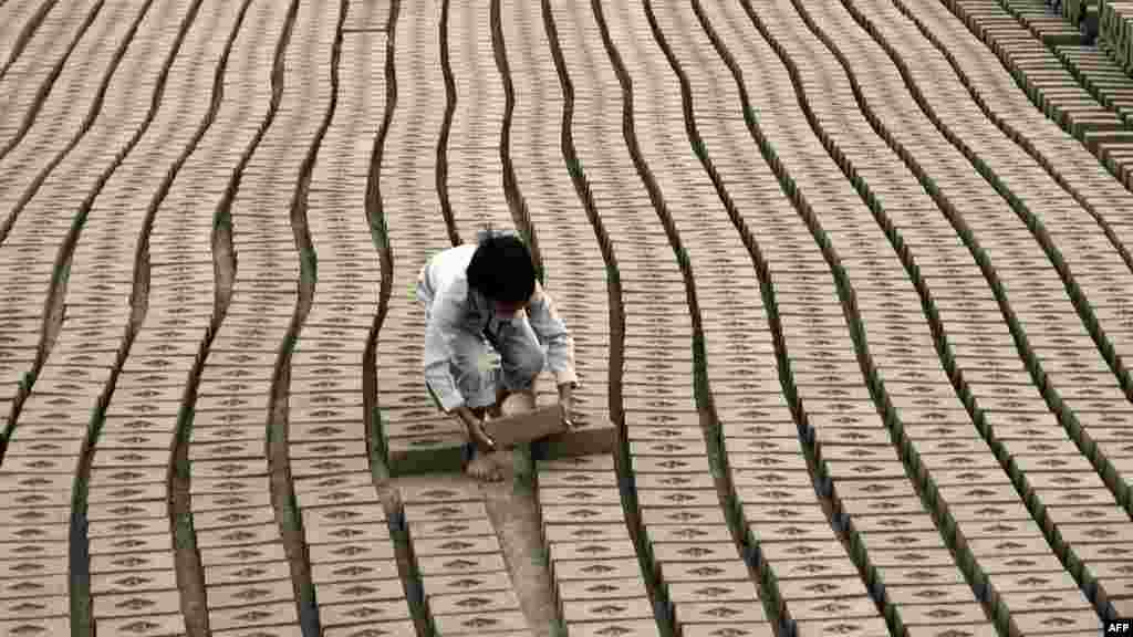 A child laborer works at a brick factory on the outskirts of Lahore, Pakistan. (AFP/Arif Ali)