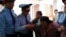 Полицейские задерживают активистку группы алматинских пенсионеров Райхангуль Амирбекову в здании акимата города. Алматы, 4 октября 2013 года.