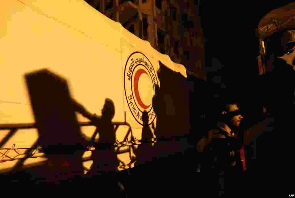 People unload supplies from a Syrian Arab Red Crescent truck in the rebel-held town of Douma on the eastern outskirts of Damascus, Syria. (AFP/Abd Doumany)