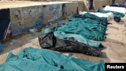Body bags containing African migrants, who drowned trying to reach Italian shores