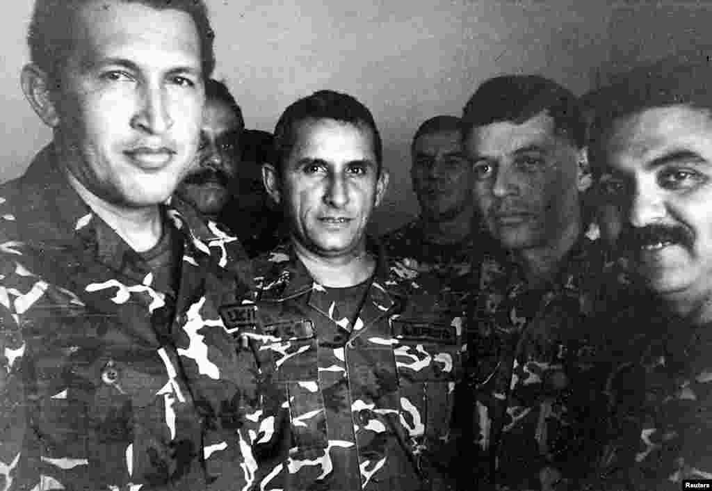 Chavez (left) is shown in a 1992 file photo in jail after being arrested for a coup attempt.