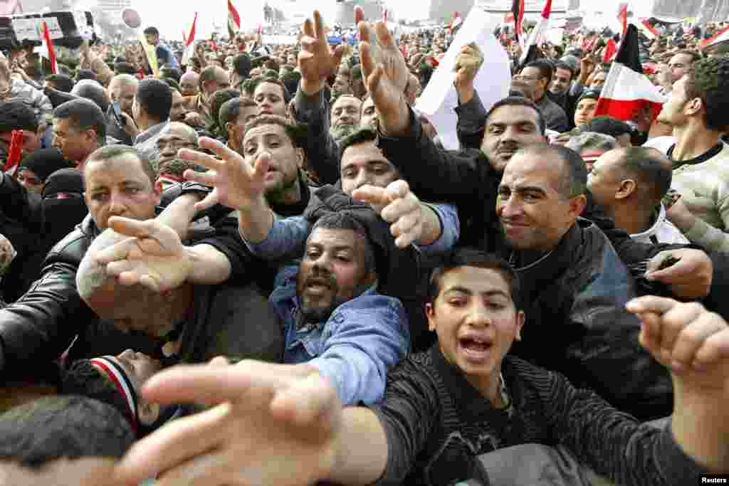 Hungry and thirsty protesters reach out for food and drink during mass demonstrations in Tahrir Square on February 8, 2011.