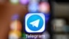RUSSIA -- An illustration picture taken through a magnifying glass shows the icon of the popular messaging app Telegram on a smart phone screen - generic