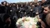 Iranians mourn at a funeral for loved ones killed in recent air strikes, at the Behesht Zahra cemetery in southern Tehran on March 26.