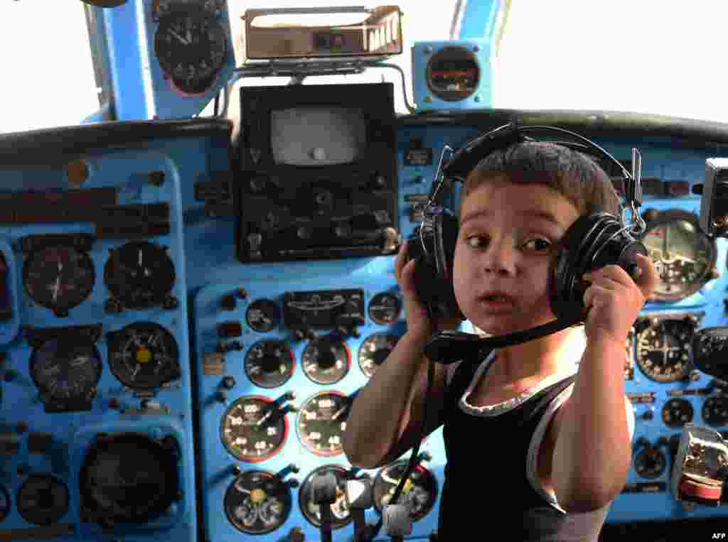 A boy plays inside a Soviet-era Yakovlev Yak-40 plane that was turned into a indergarten in the Georgian city of Rustavi. Local head teacher Gari Chapidze bought the old but fully functional Yak-40 from Georgian Airways and refurbished its interior with educational equipment, games, and toys but left the cockpit instruments intact so they could be used as play tools. (AFP/Vano Shlamov)