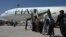Passengers board a Pakistan International Airlines (PIA) flight, the first commercial international flight since the Taliban retook power last month, at the airport in Kabul on September 13.