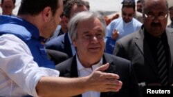 United Nations Secretary-General Antonio Guterres (center) visits a camp for internally displaced people outside Kabul on June 14.