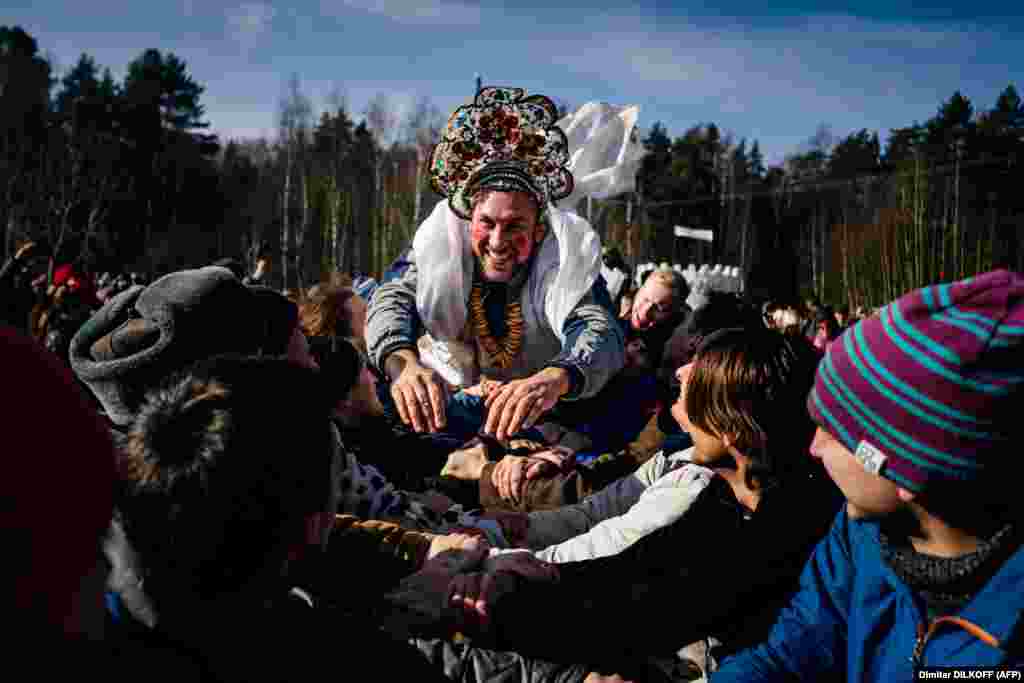 People take part in Maslenitsa celebrations close to the village of Khlyupino, some 60 km outside Moscow on March 1, 2020.