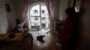 Local resident Kateryna stands inside a room of her apartment damaged by debris from a downed Russian drone in Kyiv on December 30.