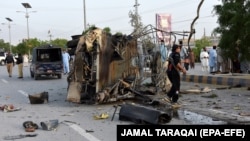 Pakistani security officials inspect a police truck after a bomb blast in in Quetta on April 24. 