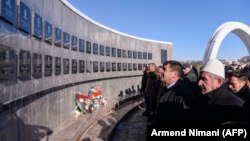 Kosovars pay their respects to victims of the Racak massacre in the village of Racak on January 15.