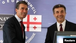 Georgian Prime Minister Bidzina Ivanishvili (right) meets with NATO Secretary-General Anders Fogh Rasmussen in Tbilisi on June 26.