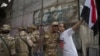 An Egyptian man welcomes an army soldier upon his deployment on a street leading to Cairo University on July 3. 