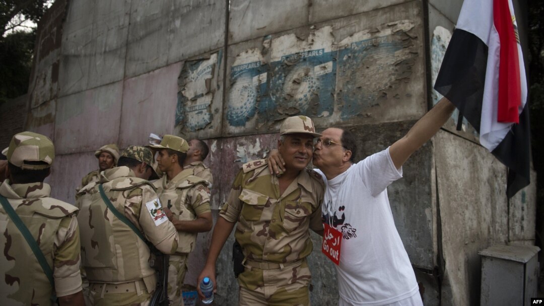 An Egyptian man welcomes an army soldier upon his deployment on a street leading to Cairo University on July 3. 