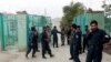 Afghan policemen stand guard near the site of blasts in the capital Kabul on June 3.