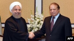 Pakistani Prime Minister Nawaz Sharif, right, meets with Iranian President Hassan Rohani after the 10-nation Economic Cooperation Organization (ECO) summit in Islamabad on March 1.