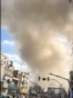 This video grab taken from UGC images posted on social media on February 28, 2026, and verified by AFPTV teams in Paris, shows traffic moving as a plume of smoke rises following a repoted explosion in Tehran.
