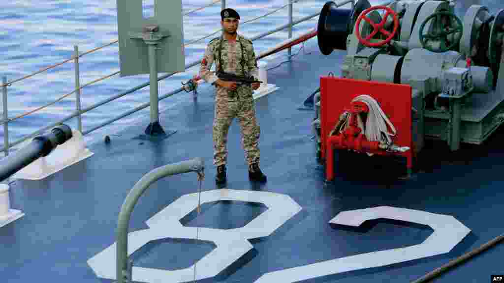 An Iranian navy special forces officer holds an Uzi sub-machine gun on the deck of the “Shahid Naqdi” as it pulls into port.