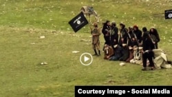 A screenshot from the IS video, showing prisoners being led to their deaths.