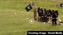 A screenshot from the IS video, showing prisoners being led to their deaths.