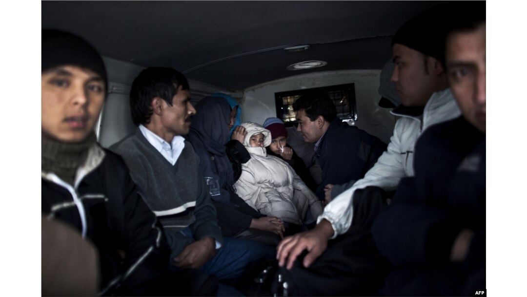 A group of Afghan and Palestine migrants is seen inside a police van in Nea Vissa, Greece. (file photo)