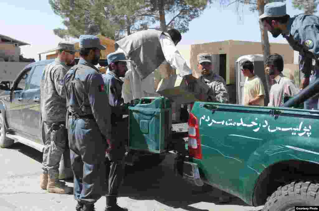 On the ground, Radio Azadi works with local authorities, community leaders, and the Afghan police to coordinate and secure the distribution effort. Here, Afghan police are loading radios onto cars in Shindand province.