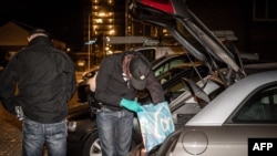 Dutch police officers search a car as he conducts an investigation at the residence of an alleged jihadist in Arnhem, on September 27, 2018. Dutch police arrested seven men suspected of plotting to carry out a "major terrorist attack" at a public event us