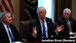 U.S. President Donald Trump, flanked by U.S. Senator Dick Durbin (D-IL) and Representative Steny Hoyer (D-MD), holds a bipartisan meeting with legislators on immigration reform at the White House in Washington, U.S. January 9, 2018