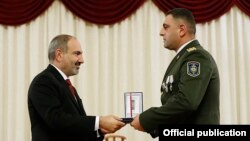 Armenia -- Prime Minister Nikol Pashinian awards a medal to a National Security Service officer, Yerevan, December 19, 2019.