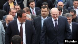 Armenia - Belarusian President Aleksandr Lukashenko (R) and businessman Gagik Tsarukian attend the opening of a new church in Abovian, 14May2013.