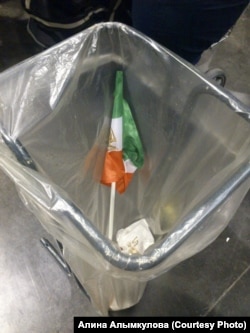 An Iranian flag is seen in the trash after the rally.