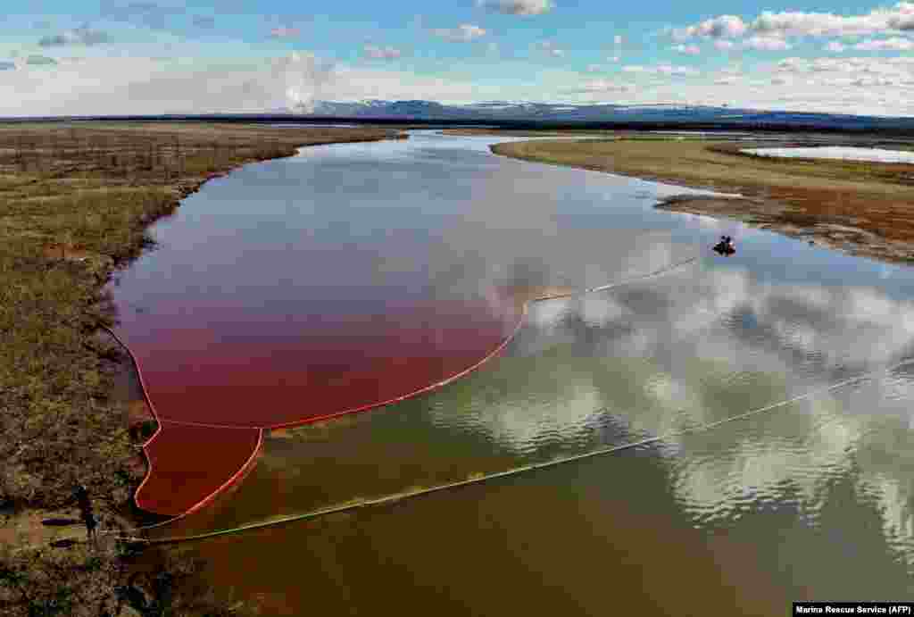 The Ambarnaya River, outside the Russian industrial city of Norilsk in Siberia, is colored red on June 3 following a massive diesel spill in late May. (AFP)