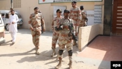 Pakistani rangers secure the school premises after unknown culprits threw a hand grenade at a school in Karachi