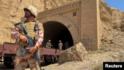 Pakistan army soldiers stand at a tunnel where the Jaffar Express train was attacked by separatist militants, in Bolan, Balochistan, Pakistan, March 15, 2025