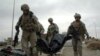 U.S. soldiers carry a body away from the site of an earlier suicide attack in Al-Ramadi (file photo)