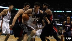 Zaza Pachulia (second from left) and Josh Smith of the Atlanta Hawks surround Ersan Ilyasova (center) of the Milwaukee Bucks as they battle for the ball during a 2010 NBA playoff game in Milwaukee.