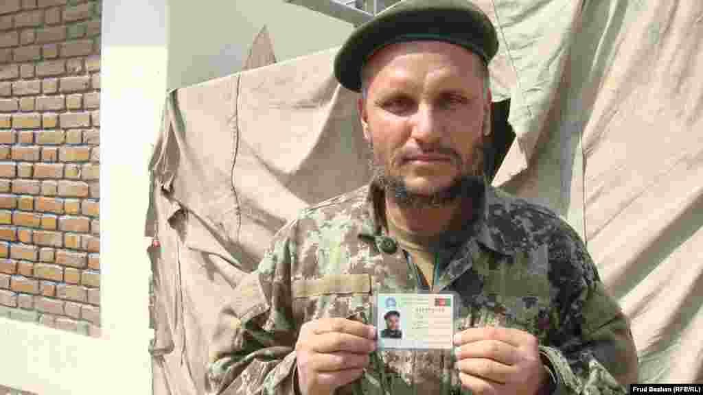 An Afghan soldier gets a new voter card.
