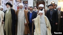 Ahmad Jannati, 92, walking with a stick among his peers. FILE PHOTO