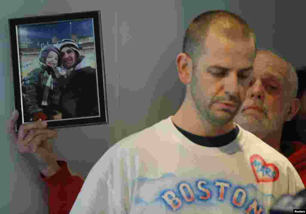 Edward Fucarile, the father of Boston Marathon bombing victim Marc Fucarile, holds up a photograph of his son as his family read a statement about his condition at Massachusetts General Hospital in Boston. Marc Fucarile&#39;s injuries included having his right leg amputated, multiple fractures in his left leg, and shrapnel in his body, including his heart.