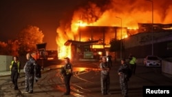 Police officers and security guard a supermarket warehouse hit by a Russian missile strike in Kyiv on August 5.