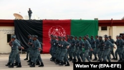 Afghan policemen march during a graduation ceremony in Helmand on February 6.