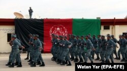 Afghan police officers march during a graduation ceremony.