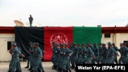 FILE: Afghan policemen march during their graduation ceremony in Helmand, February 2018.