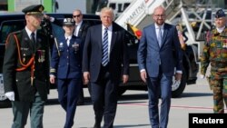 U.S. President Donald Trump (center) walks beside Belgian Prime Minister Charles Michel (right) upon arriving at Brussels airport on May 24.