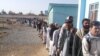 FILE: Voters in the southern province of Helmand wait to cast their votes in April 2014.