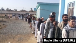 FILE: Voters in the southern province of Helmand wait to cast their votes in April 2014.