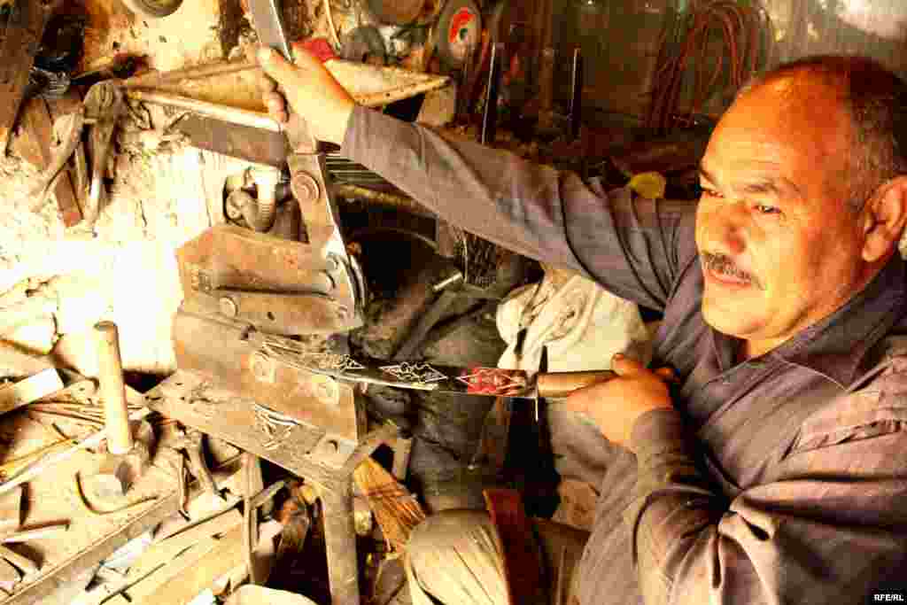 Knifemaker Davud crafts a blade, a skill he has developed over 22 years. He says his business is now struggling. - Zanjan is famous for its knives, but many workshops have shut down in recent years, unable to make ends meet.